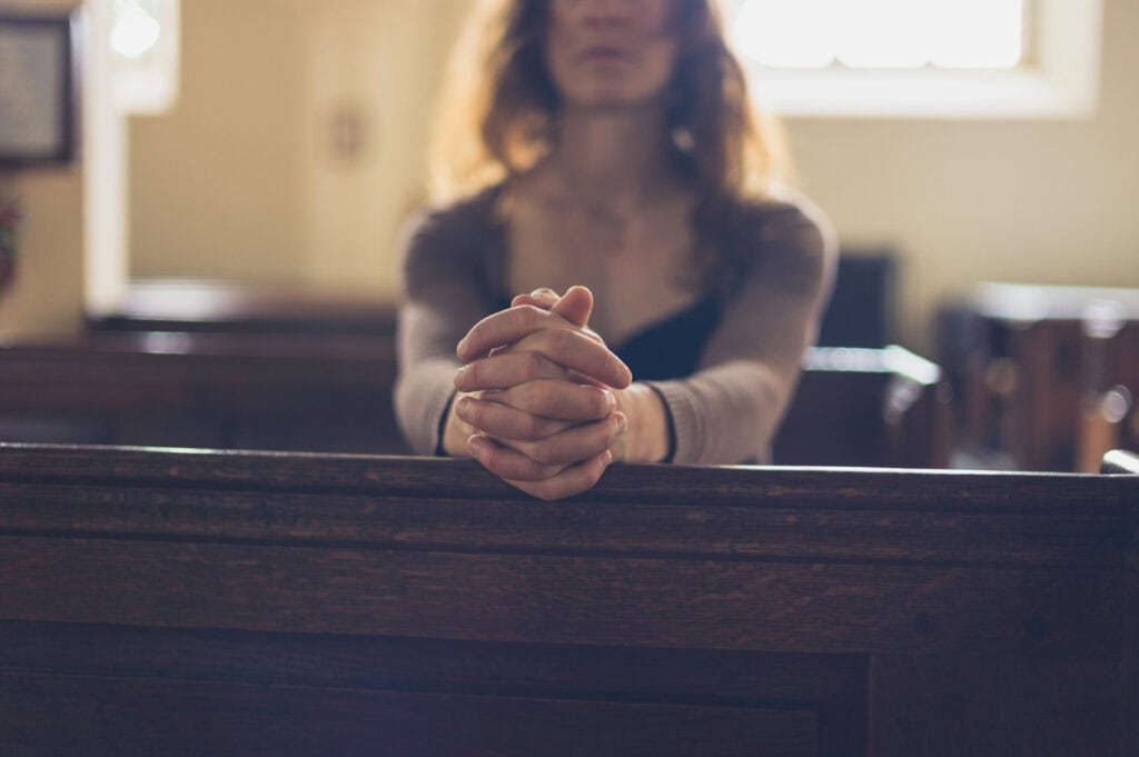 woman praying in church
