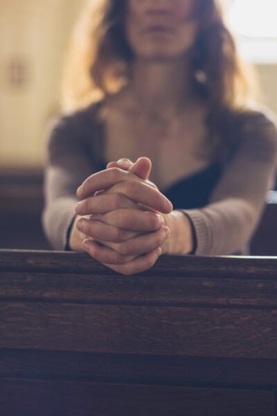 woman praying in church